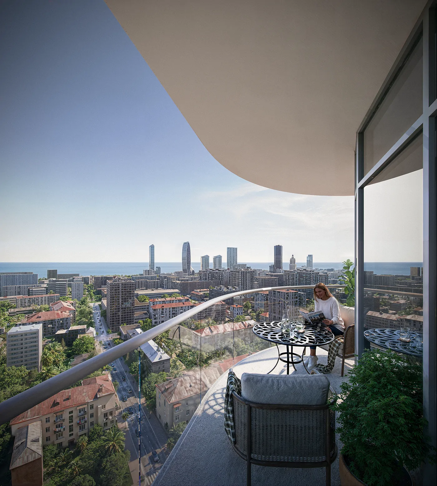 A resident on a curved private balcony high above Batumi, the city and the Black Sea beyond
